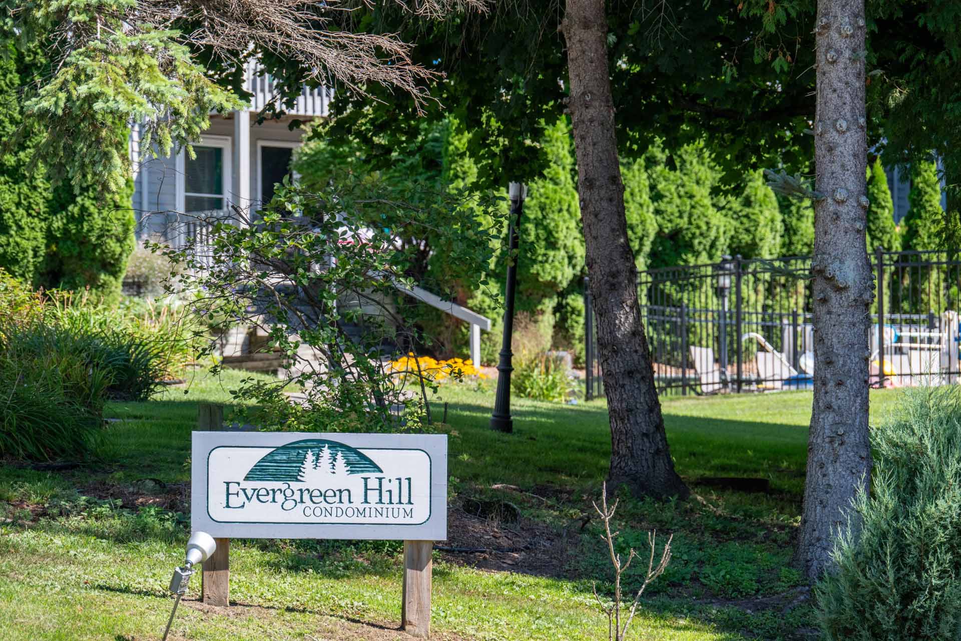Evergreen Condos Fish Creek Wisconsin Summer Update-9 The grounds at Evergreen Condominiums with the sign in the foreground